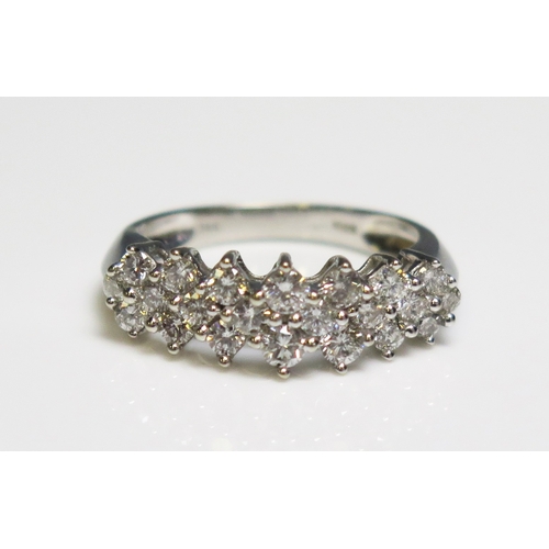 302 - A 14 ct white gold ring set with twenty small diamonds, 3.4gms, size N/N.5.