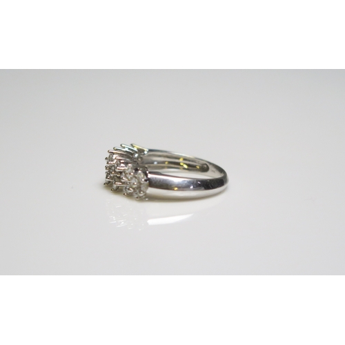 302 - A 14 ct white gold ring set with twenty small diamonds, 3.4gms, size N/N.5.