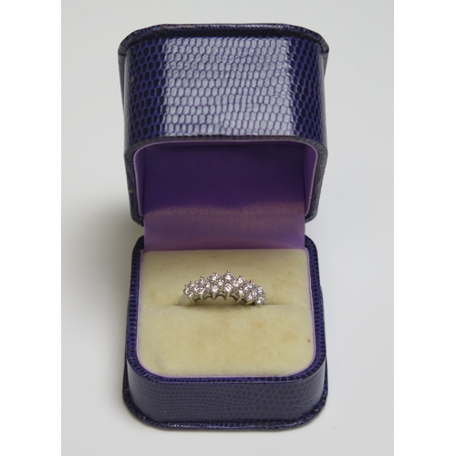 302 - A 14 ct white gold ring set with twenty small diamonds, 3.4gms, size N/N.5.