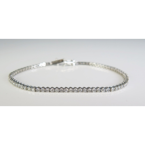 306 - A 9ct white gold and diamond set line/tennis bracelet, with seventy seven diamonds, 190cm long.