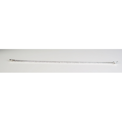 306 - A 9ct white gold and diamond set line/tennis bracelet, with seventy seven diamonds, 190cm long.