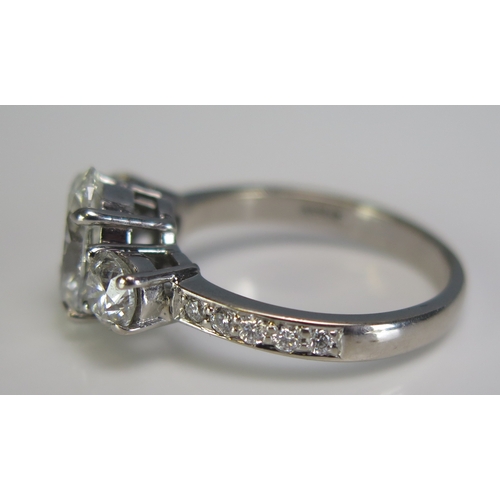 308 - An 18ct white gold three stone diamond ring, the central 2ct laboratory grown diamond flanked by two... 