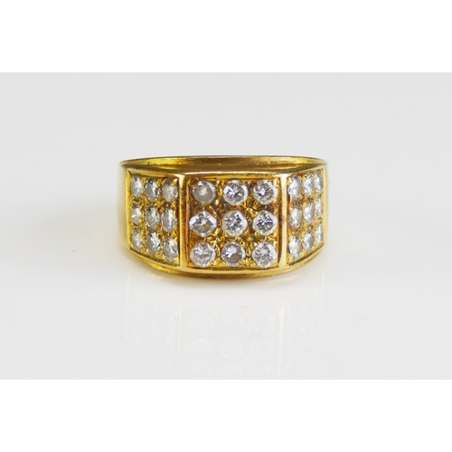 40 - An 18ct Gold and Diamond Ring, set with 2.3mm brilliant cuts arranged in three panels of nine, size ... 