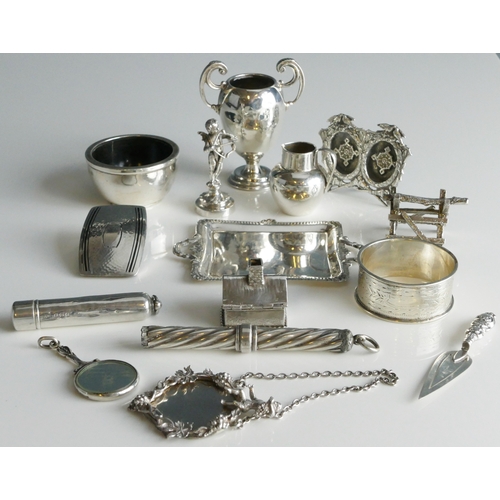 511 - A mixed collection of silverwares, various makers and dates, includes, miniature trophy cup, napkin ... 