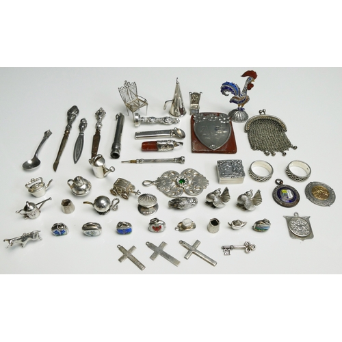 514 - A collection of silver and other novelties, including charms, patch box, purse etc