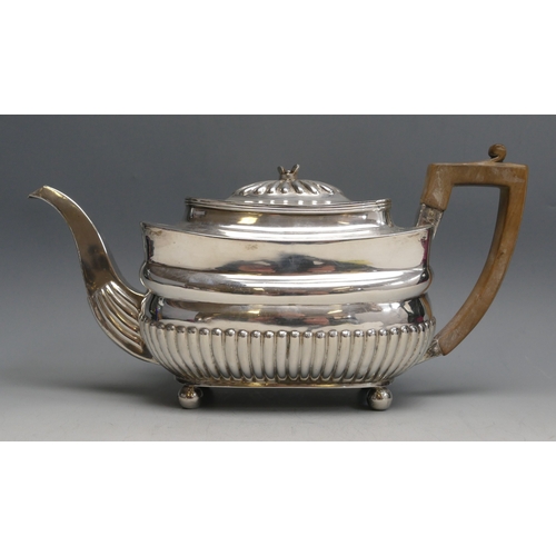 520 - A George III silver teapot, maker C.H? London, 1807, of barge-shaped outline with half reeded decora... 