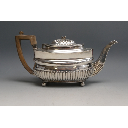 520 - A George III silver teapot, maker C.H? London, 1807, of barge-shaped outline with half reeded decora... 