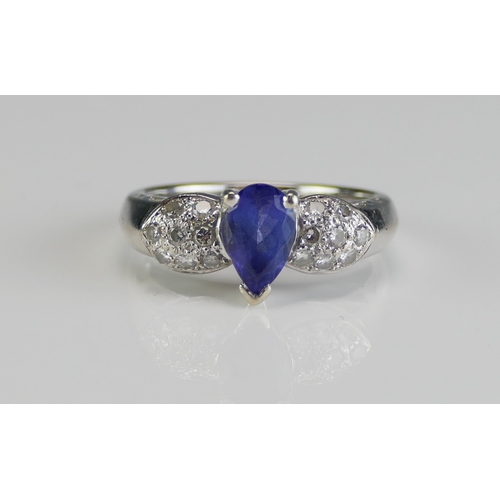 54 - A 14K White Gold, Tanzanite and Diamond Dress Ring, c. 7.8x4.9mm principal stone, size N.5, stamped ... 