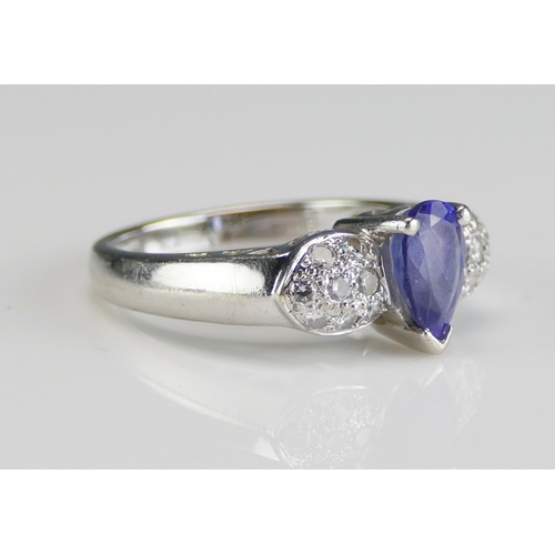 54 - A 14K White Gold, Tanzanite and Diamond Dress Ring, c. 7.8x4.9mm principal stone, size N.5, stamped ... 