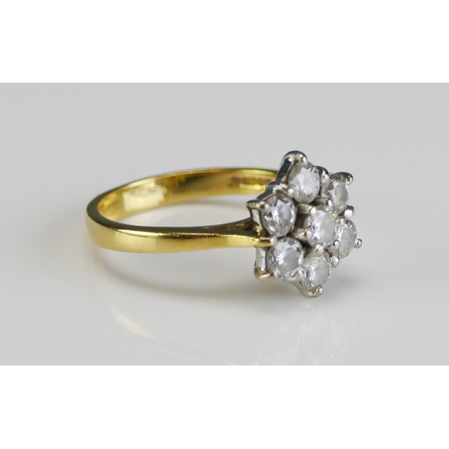 60 - An 18ct Gold and Diamond Seven Stone Flower Head Cluster Ring, 11.9mm diam. head, size L, hallmarked... 