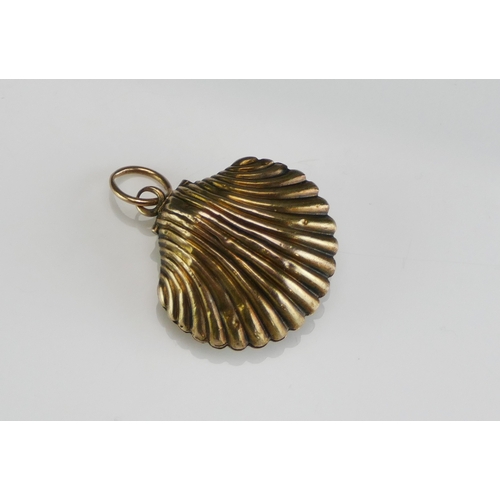 61 - An Antique Precious Yellow Metal Clam Shaped Memorial Locket containing a memento of platted hair, 2... 