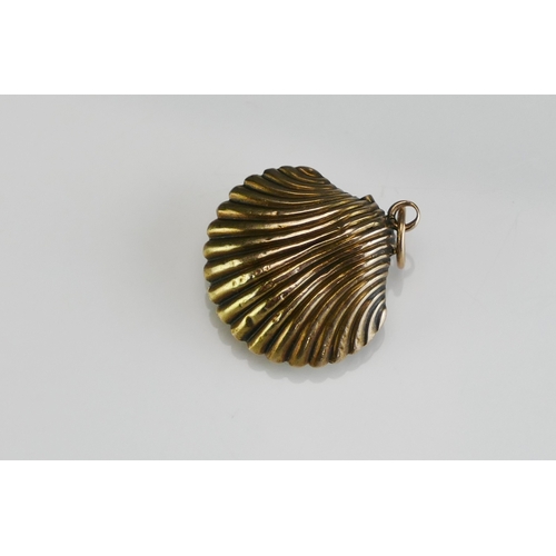 61 - An Antique Precious Yellow Metal Clam Shaped Memorial Locket containing a memento of platted hair, 2... 