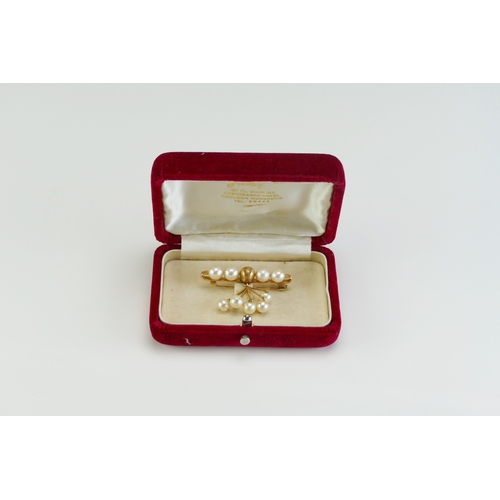 67 - An 'Oriental Pearl' 14K Gold and Cultured Pearl Brooch in original box, 48mm wide, stamped 14K, 9.63... 