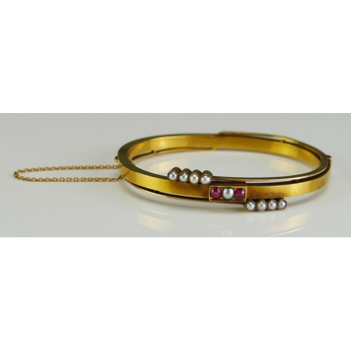 7 - An Antique Russian 14ct Gold, Ruby and Split Pearl Hinged Bangle with safety chain, c. 16.5cm circum... 