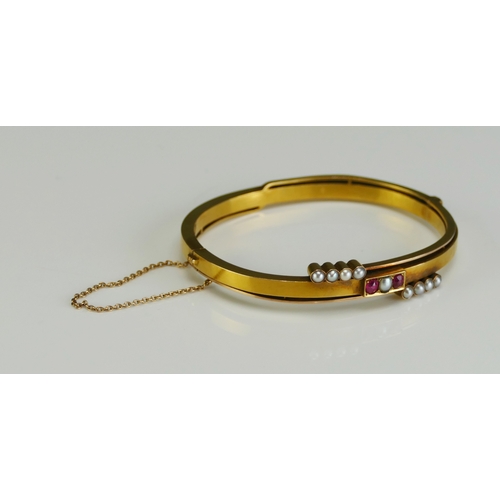 7 - An Antique Russian 14ct Gold, Ruby and Split Pearl Hinged Bangle with safety chain, c. 16.5cm circum... 