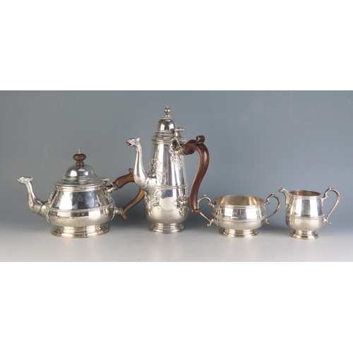 A George V silver three-piece tea service, maker Horace Woodward & Co, Birmingham, 1920, of circular form with ribbed girdle and spot in the form of a mythical beast, includes teapot, sugar basin, milk jug, together with a matched coffee pot by Adie Brothers Ltd, London, 1920, total weight of silver 2190gms, 70.42ozs