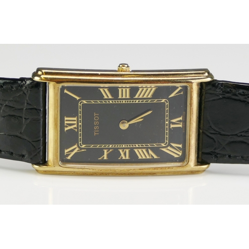 78 - A TISSOT Gent's 9ct Gold Dress Watch, the quartz movement with a black dial and original Tissot stra... 