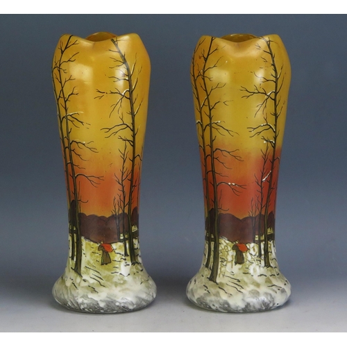 1728 - A pair of late Victorian orange glass vases decorated with a winter scene, 28cm high.