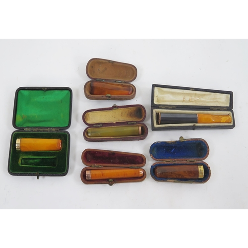 1743 - Two 9ct gold and One 15ct gold mounted cheroot holders in Morocco leather cheroot holder cases, 9ct,... 