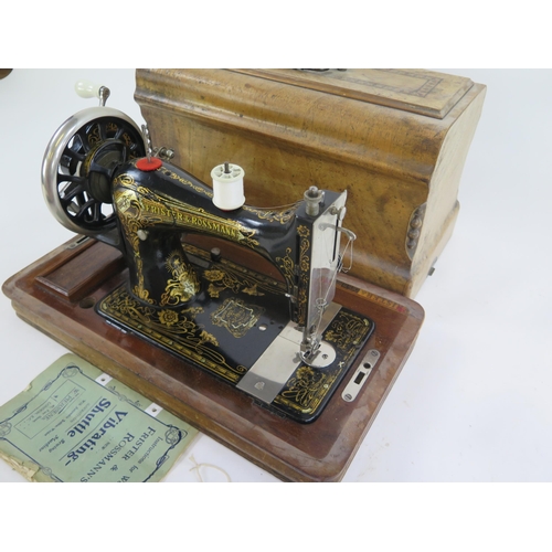 1776 - A Frister & Rossmann sewing machine, with gilt transfer print decoration, together with instruction ... 