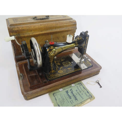 1776 - A Frister & Rossmann sewing machine, with gilt transfer print decoration, together with instruction ... 