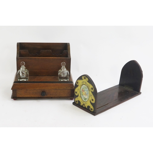 1779A - A Victorian mahogany stationery stand, with glass inkwells and single drawer to the base, 27cm wide,... 