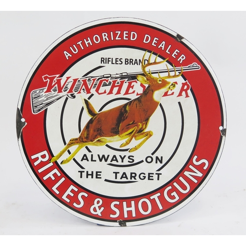 1807 - A reproduction enamel advertising sign 'Winchester Rifles and Shotguns', 31cm diameter.