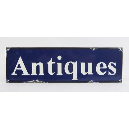 1810 - A reproduction enamel advertising sign 'Antiques', 15 x 51cm.