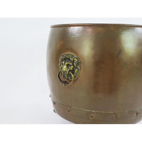 1817 - A large copper log cauldron, raised on three paw feet, 42cm high, 41cm diameter.