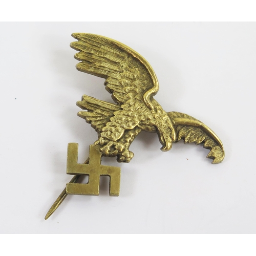 1821 - A World War II gilt brass Luftwaffe stick pin, of an eagle holding a swastika.