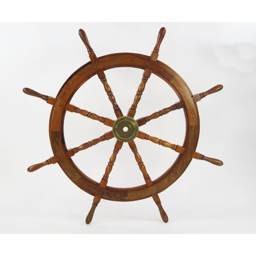 1822 - A polished hardwood eight spoke ships wheel, with central brass boss, 107cm diameter.