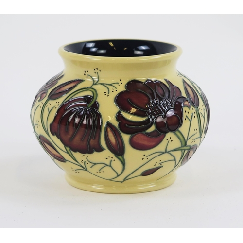 1860 - A Moorcroft pottery case of squat circular form with piped floral decoration, 13cm diameter.