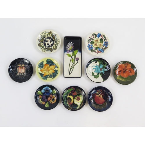 1867 - Moorcroft Pottery, ten circular and rectangular small dishes with piped floral decoration. two boxed... 