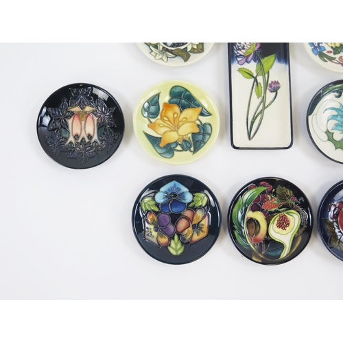 1867 - Moorcroft Pottery, ten circular and rectangular small dishes with piped floral decoration. two boxed... 