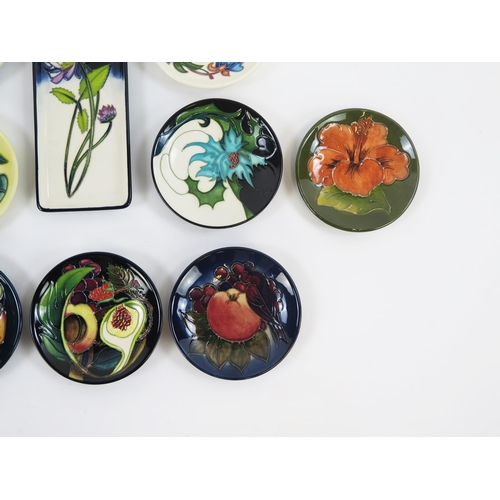 1867 - Moorcroft Pottery, ten circular and rectangular small dishes with piped floral decoration. two boxed... 