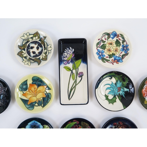 1867 - Moorcroft Pottery, ten circular and rectangular small dishes with piped floral decoration. two boxed... 