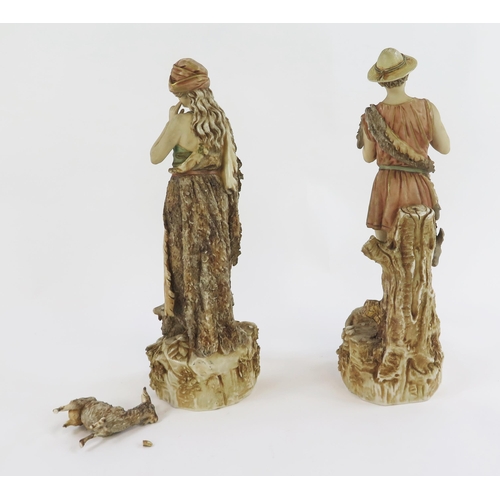 1868 - A pair of Royal Dux style figurines of a shepherd and shepherdess, on naturalistic bases with sheep,... 