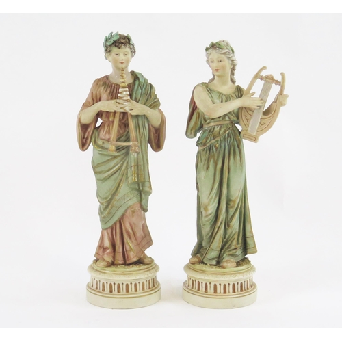 1869 - A pair of Royal Dux style neoclassical musicians, the female with a harp the male with twin pipes, 2... 