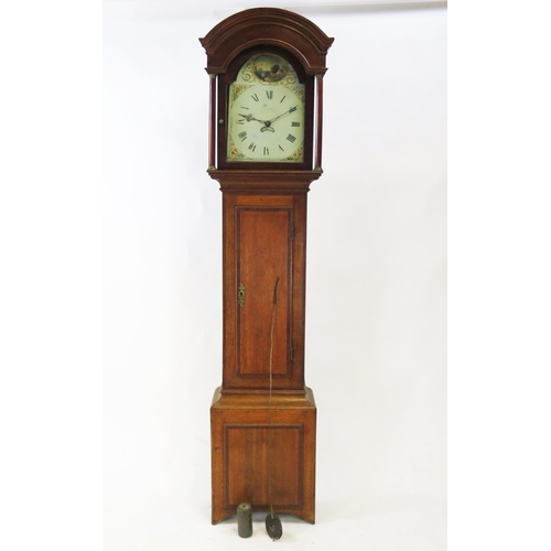 1892A - A 19th century oak longcase clock, the arched hood with turned columns, the trunk with cross banded ... 