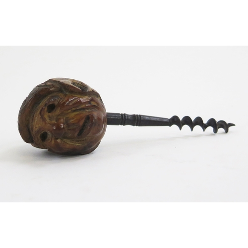 1918 - A novelty pull corkscrew, with grotesque head pommel 15cm long.