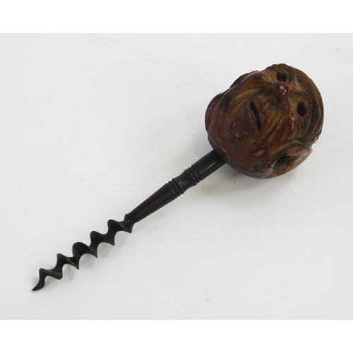 1918 - A novelty pull corkscrew, with grotesque head pommel 15cm long.