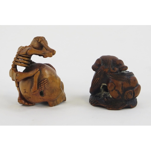 1922 - A Carved boxwood netsuke in the form of a skeleton climbing on a skull, signed, 5cm high, together w... 