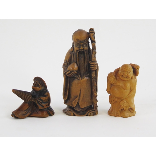 1923 - A carved boxwood netsuke in the form of hotei, signed, 5cm high, another netsuke of a man with a par... 