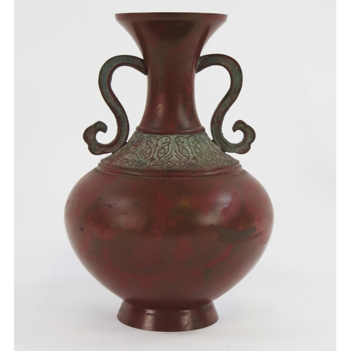 1924 - A Japanese bronze vase of archaic design, with scroll handles and banded decoration to the neck, ins... 