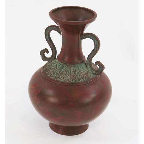 1924 - A Japanese bronze vase of archaic design, with scroll handles and banded decoration to the neck, ins... 