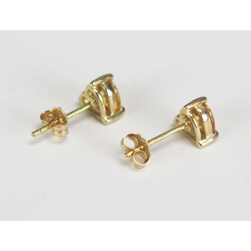 279 - A pair of heart-shaped yellow sapphire ear studs mounted in 9ct gold settings.