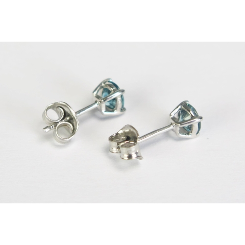 280 - A pair of blue zircon ear studs mounted in 9ct white gold.