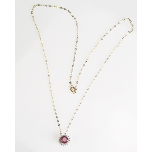 284 - A ruby and diamond halo pendant in a 9ct gold mount and chain, overall weight 1.3gms.