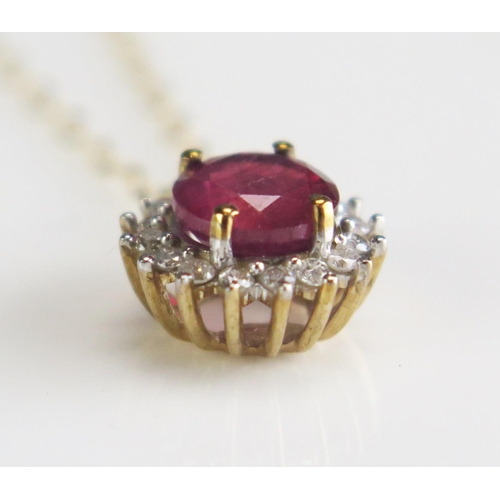 284 - A ruby and diamond halo pendant in a 9ct gold mount and chain, overall weight 1.3gms.