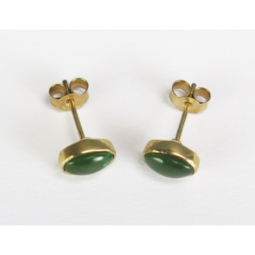 287 - A pair of green jade ear studs in 9ct gold mounts.